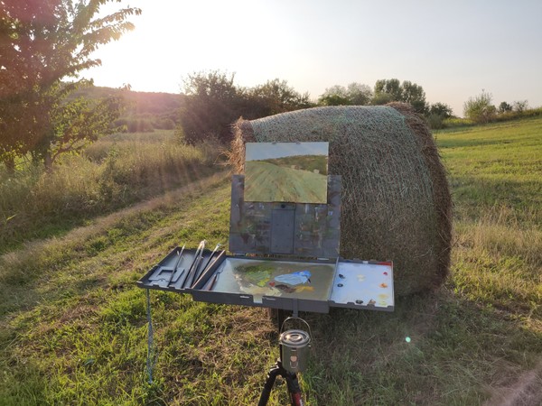 Summer field landscape painting on easel