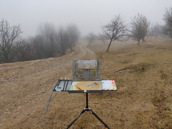 Foggy landscape painting on easel